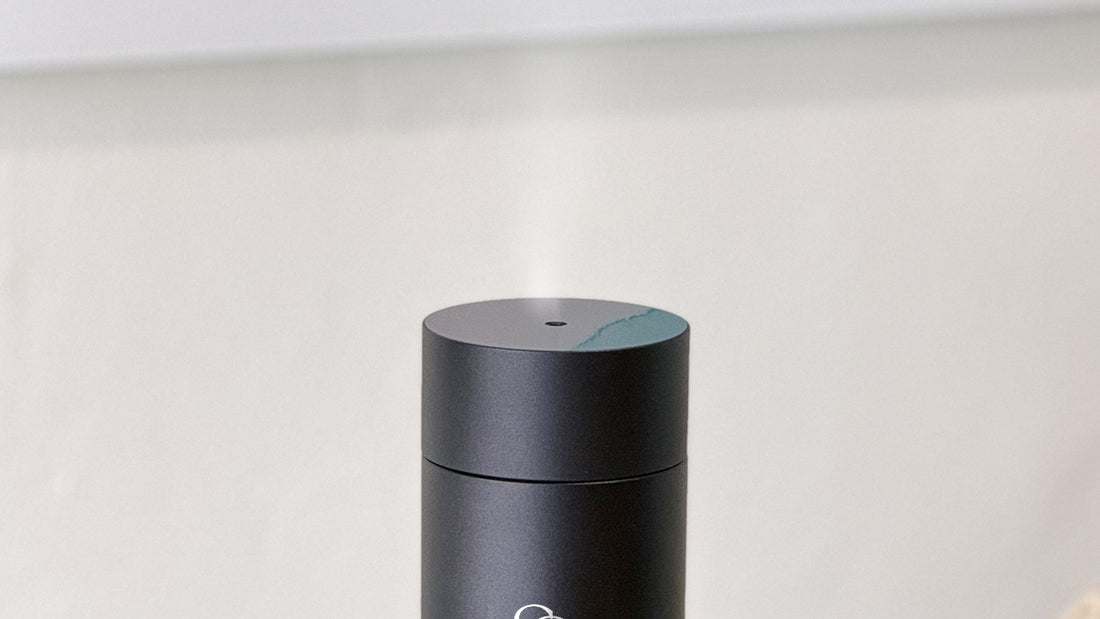 Cold air diffuser releasing a fine plume of dry fragrance mist from its nozzle