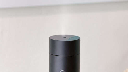 Cold air diffuser releasing a fine plume of dry fragrance mist from its nozzle