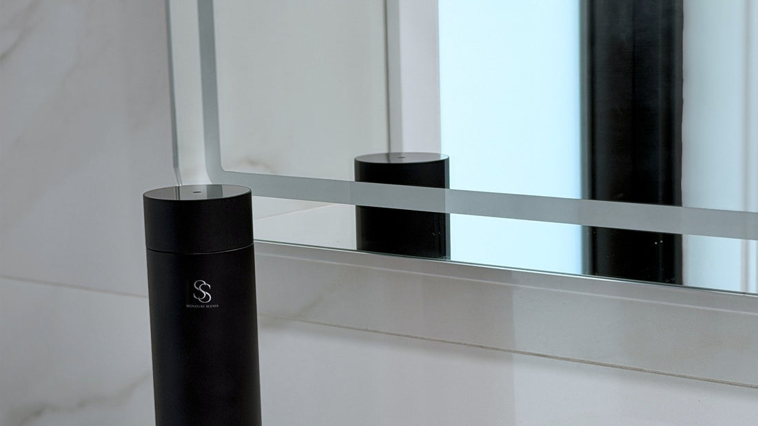 Black Tower Diffuser on a marble bathroom vanity beside a mirror, as used in luxury hotels